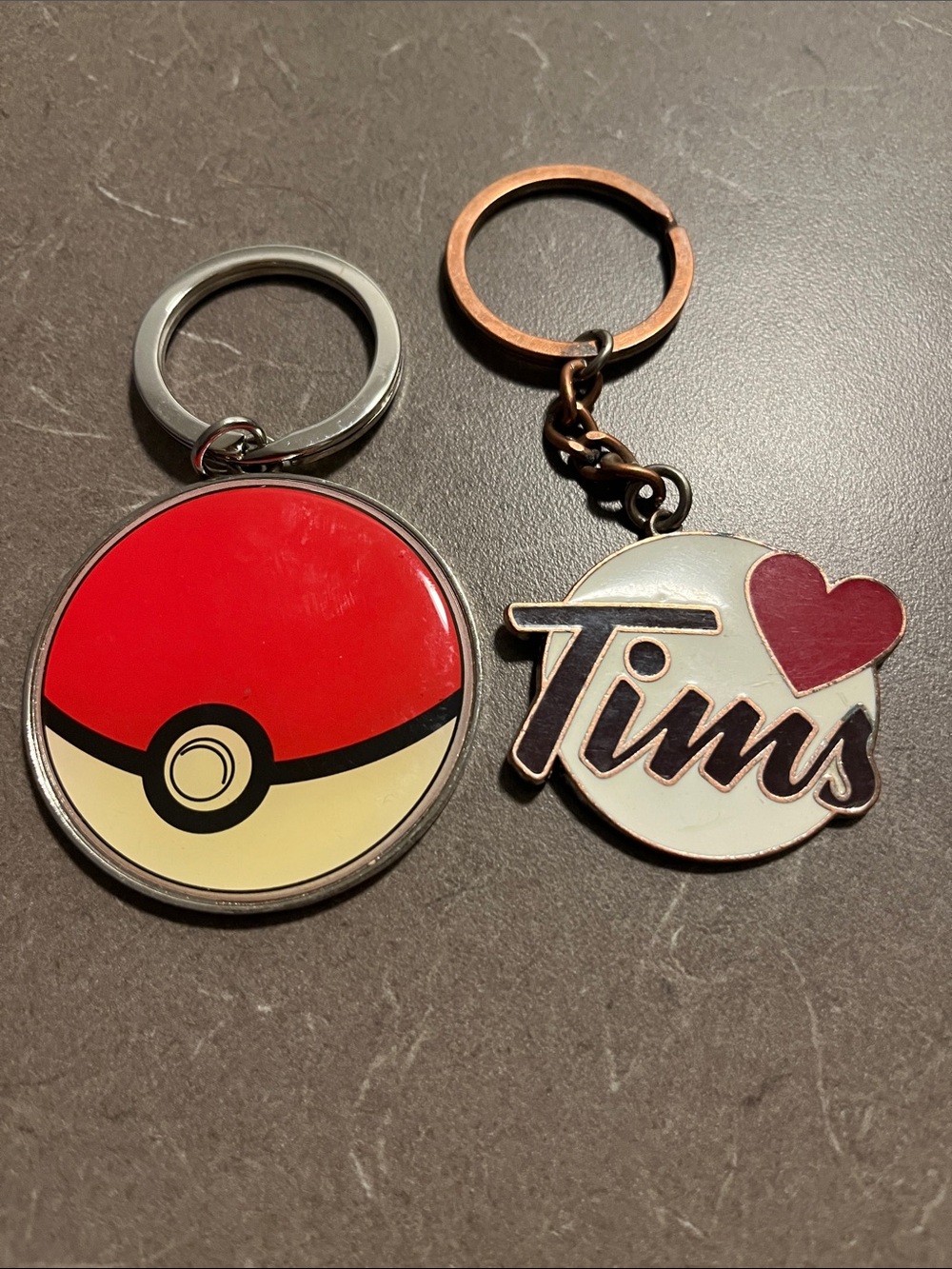 Red and Cream Poké Ball Keychain and Tim’s keychain